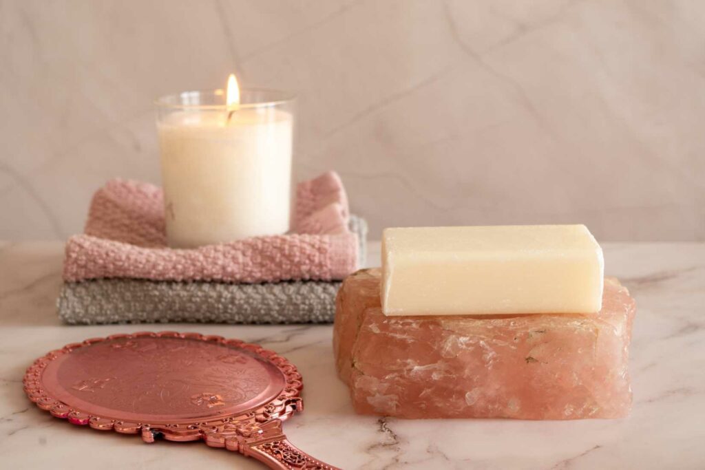 soap and candle in bathroom on marble side warm cosy colours